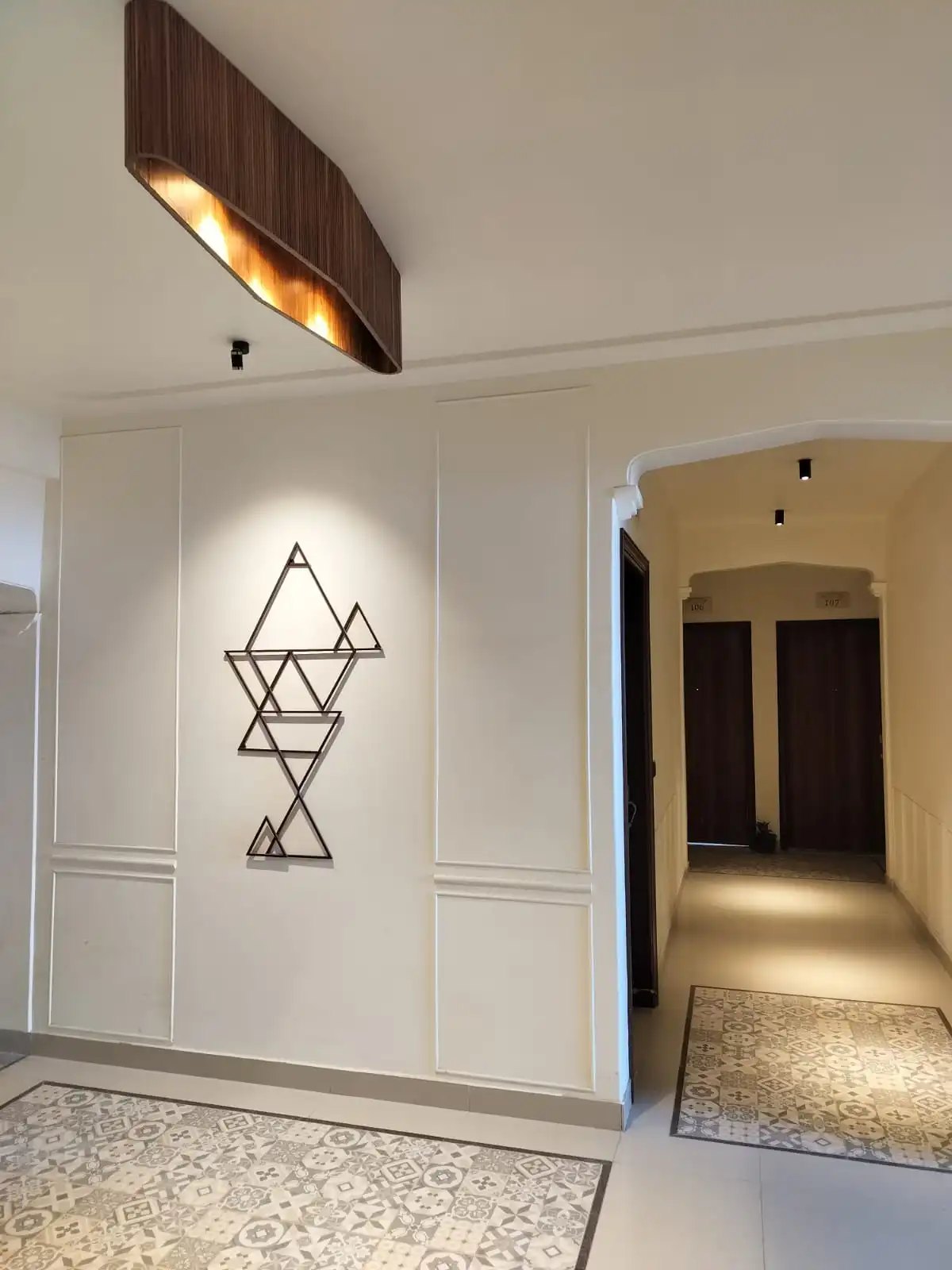 well-lit corridor with designer wall paneling
